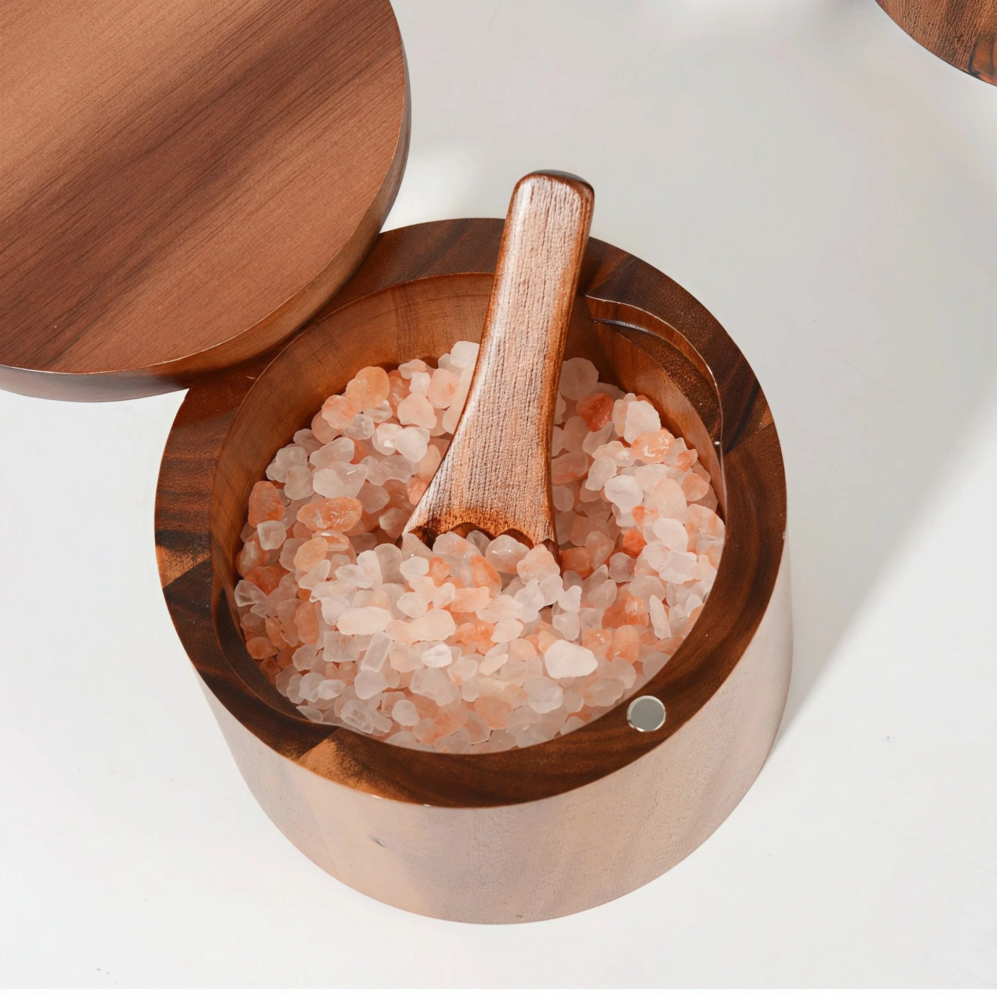 Close-up of Oakory acacia wood salt cellar filled with Himalayan pink salt and wooden spoon