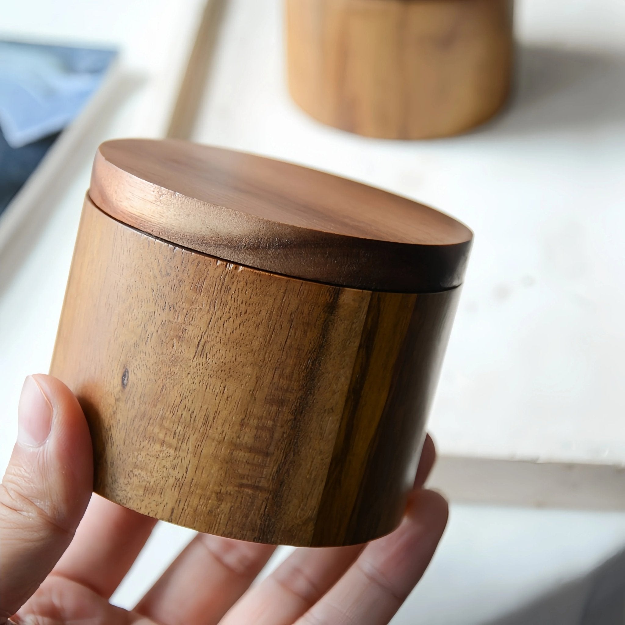 Oakory compact acacia wood salt cellar, held to show portable size