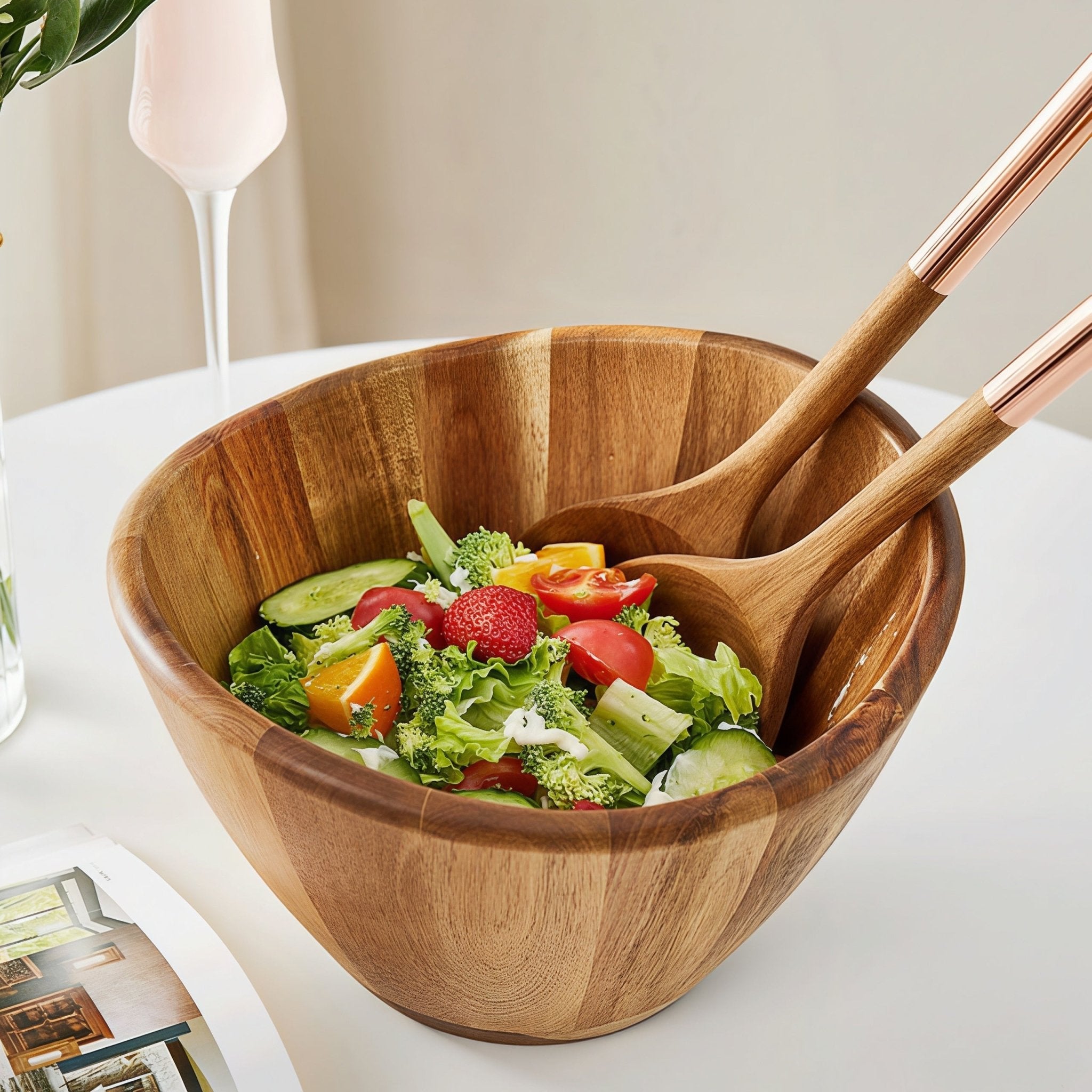 Oakory acacia wave salad bowl with wooden serving utensils, filled with fresh vegetable salad