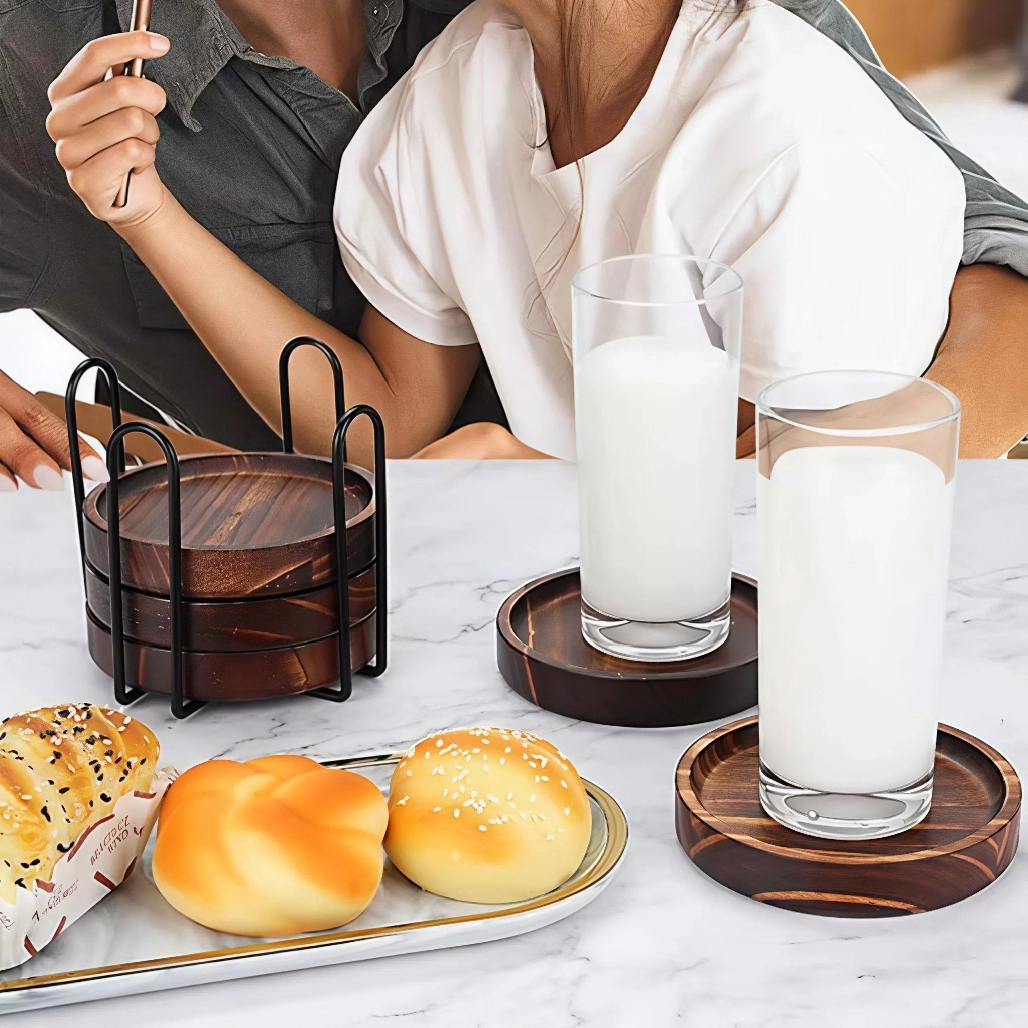 Oakory solid wood drink coasters used for milk glasses on breakfast table with pastries
