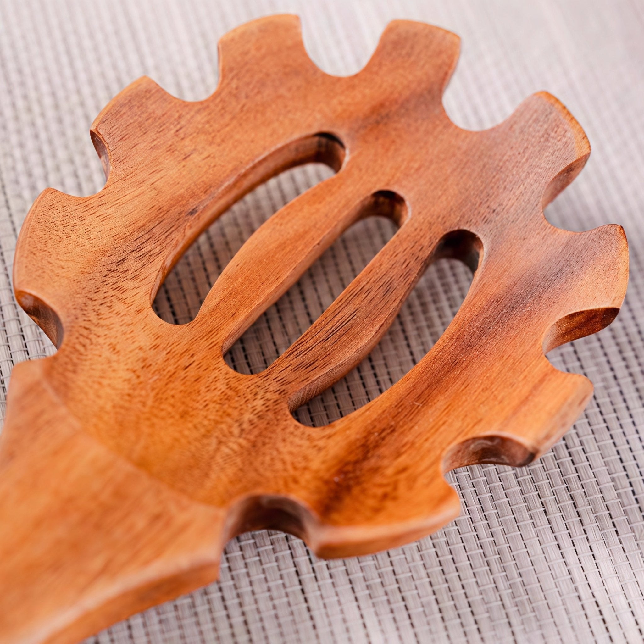 Close-up of Oakory teak pasta server showing durable wooden texture and slotted design