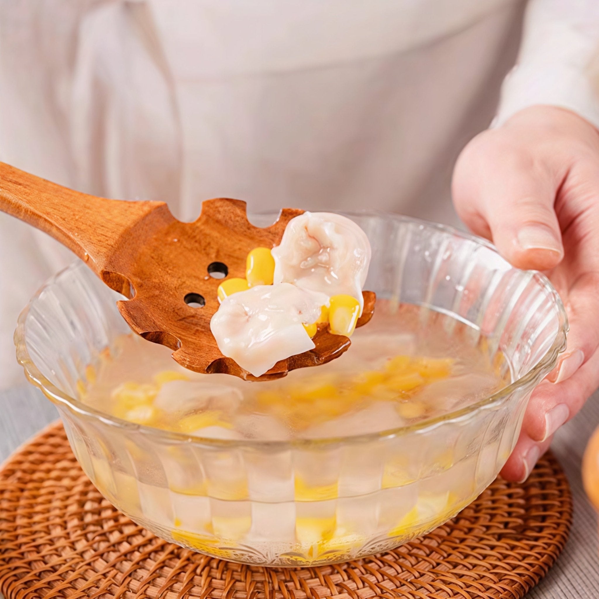 Oakory teak pasta server used for lifting dumplings and corn from soup
