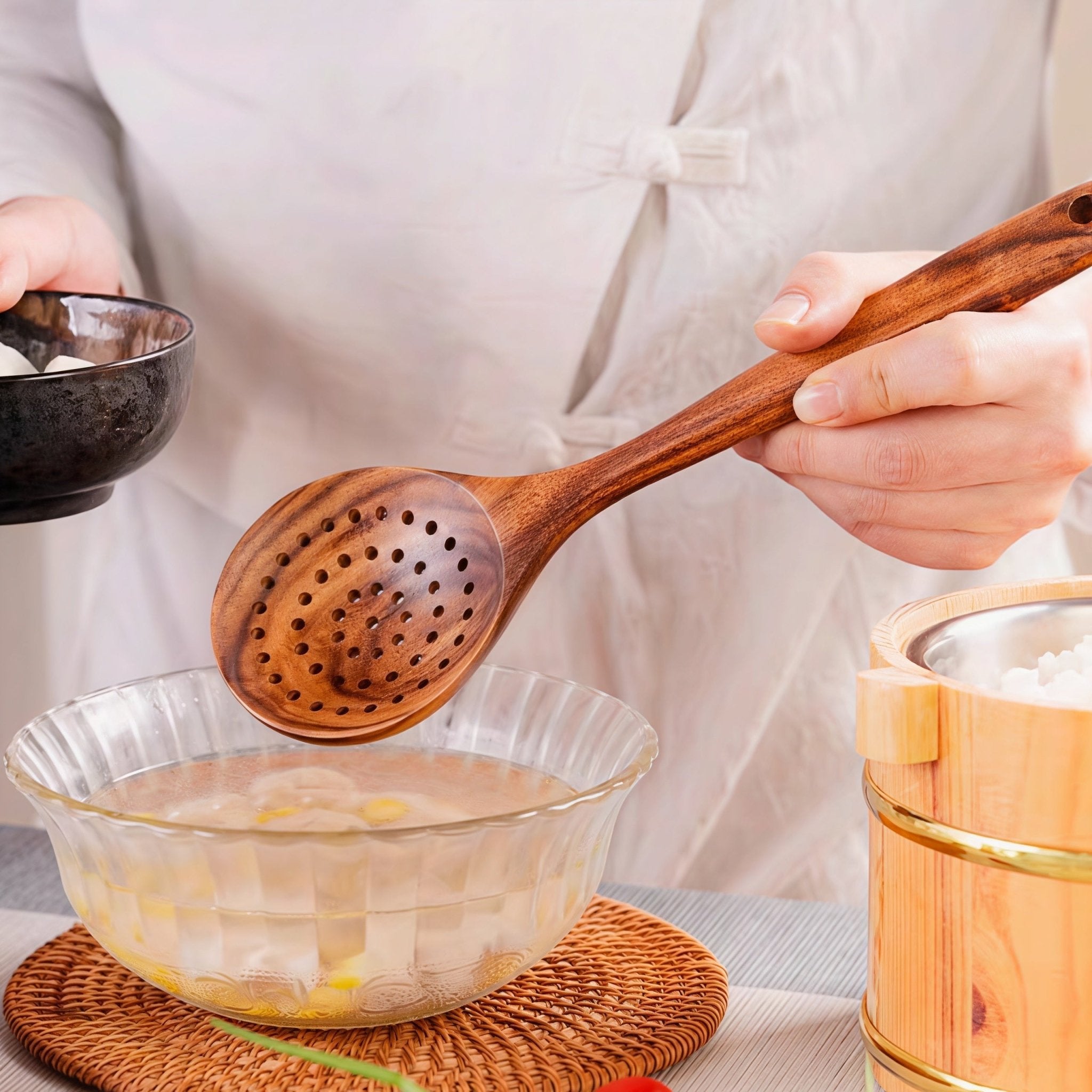 Oakory teak wooden slotted spoon used for draining soup and ingredients