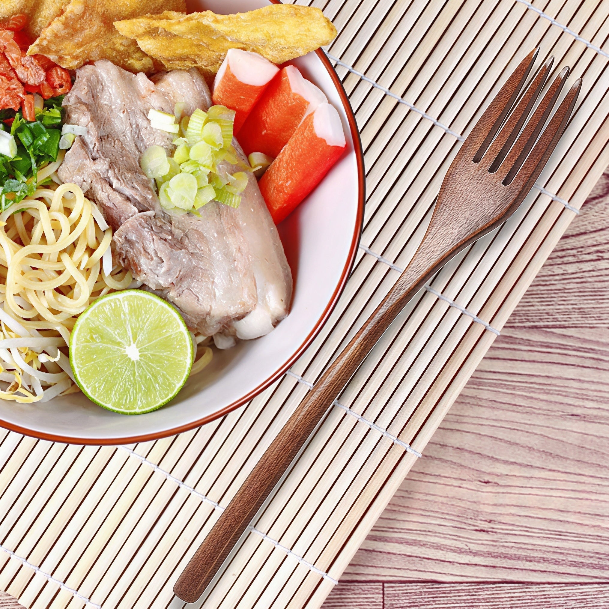 Oakory wooden fork paired with Indonesian-style noodle soup and lime